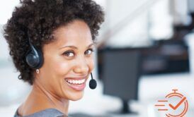 A woman with a headset, smiling brightly, showcasing excellent customer service skills and basic telephone techniques.