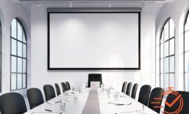 A spacious conference room with a big screen and chairs, perfect for conducting meetings and brainstorming sessions.