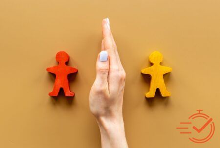 Wooden figures held up by person, representing successful conflict handling training.