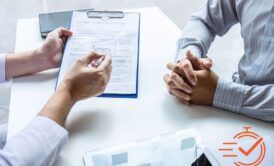 two individuals at a table with a clipboard, engaged in a consultative selling course