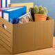 A desk showcases a box of books and pens, reflecting the process of coping with redundancy and seeking new opportunities.