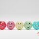 A playful display of five colorful eggs, each adorned with a smiley face, representing joy in customer service excellence.