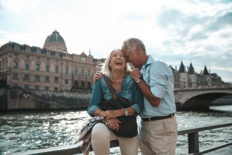 smiling couple on bridge exploring the joy of gerontology and psychology of aging