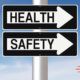 Two directional signs highlighting health and safety basics, guiding people towards essential safety information.