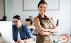 A woman in front of a computer, surrounded by colleagues, demonstrating her expertise in managing her boss effectively.