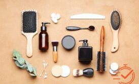 Various face and hair care items organized on a brown background, showcasing essentials for personal grooming.