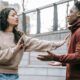 a man and woman engage in a heated discussion on the steps, highlighting the challenges of relationship building