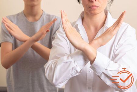 Two individuals use hand gestures to convey a message, reflecting the nuances of unconscious bias training in their interaction