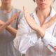 Two individuals use hand gestures to convey a message, reflecting the nuances of unconscious bias training in their interaction