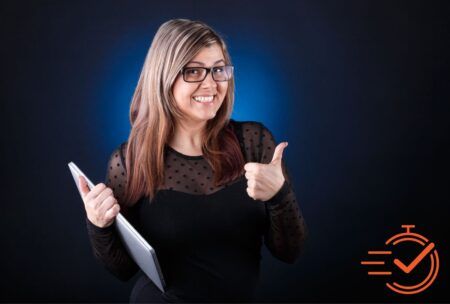 Woman with glasses and tablet giving thumbs up, showing positive attitude for ways to improve mindset.