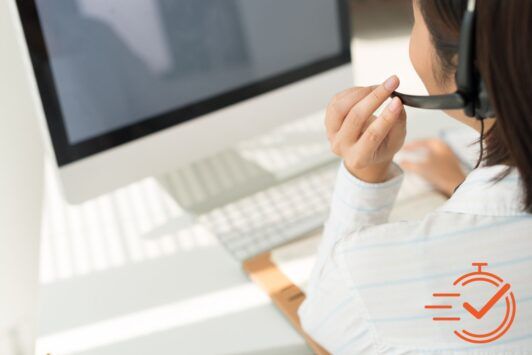 A woman in a headset, engaged in a phone call, focused on providing first contact resolution training for customer support.