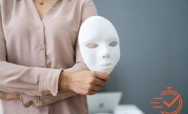 A woman holds a mask, symbolizing the importance of fraud awareness and recognizing deception