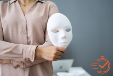 A woman holds a mask, symbolizing the importance of fraud awareness and recognizing deception