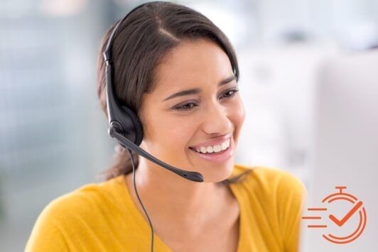 a cheerful woman with a headset uses her computer, demonstrating how to manage customer needs with ease