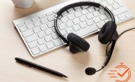 A keyboard and a headset symbolizing a call center setup, focusing on effective outbound calling strategies for better customer engagement.