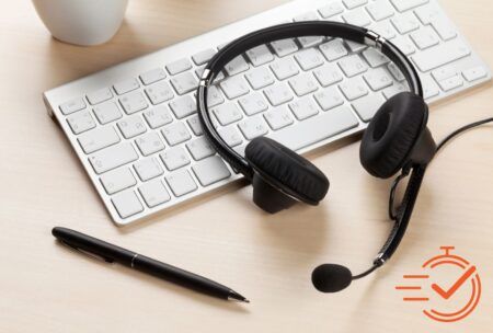 A keyboard and a headset symbolizing a call center setup, focusing on effective outbound calling strategies for better customer engagement.