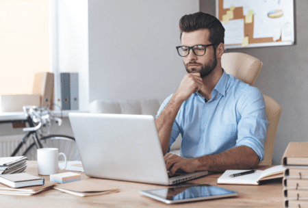 a man focused on his laptop during a power apps training session