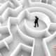 A man confidently stands in a maze, symbolizing successful problem solving course