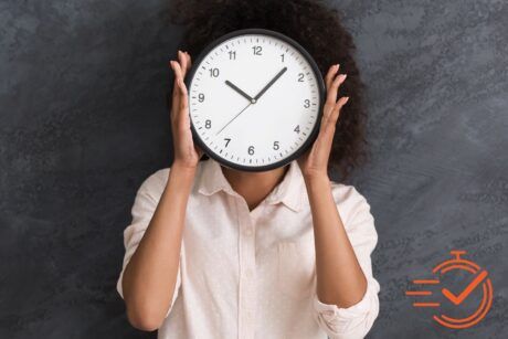 A woman covers her face with a clock, representing time management training