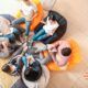 A circle of individuals on bean bags, actively participating in a collaborative training session.