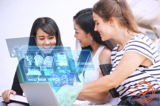 Three women collaborating over a laptop, exploring AI in the workplace together.