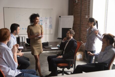 a diverse group of professionals engaged in a coaching business training meeting in a modern office setting