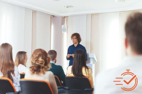 A person delivers an informative presentation to a group, fostering a collaborative learning atmosphere.