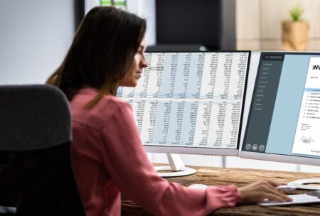 a woman analyzes data on a computer screen, utilizing the filter function excel