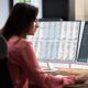 a woman analyzes data on a computer screen, utilizing the filter function excel